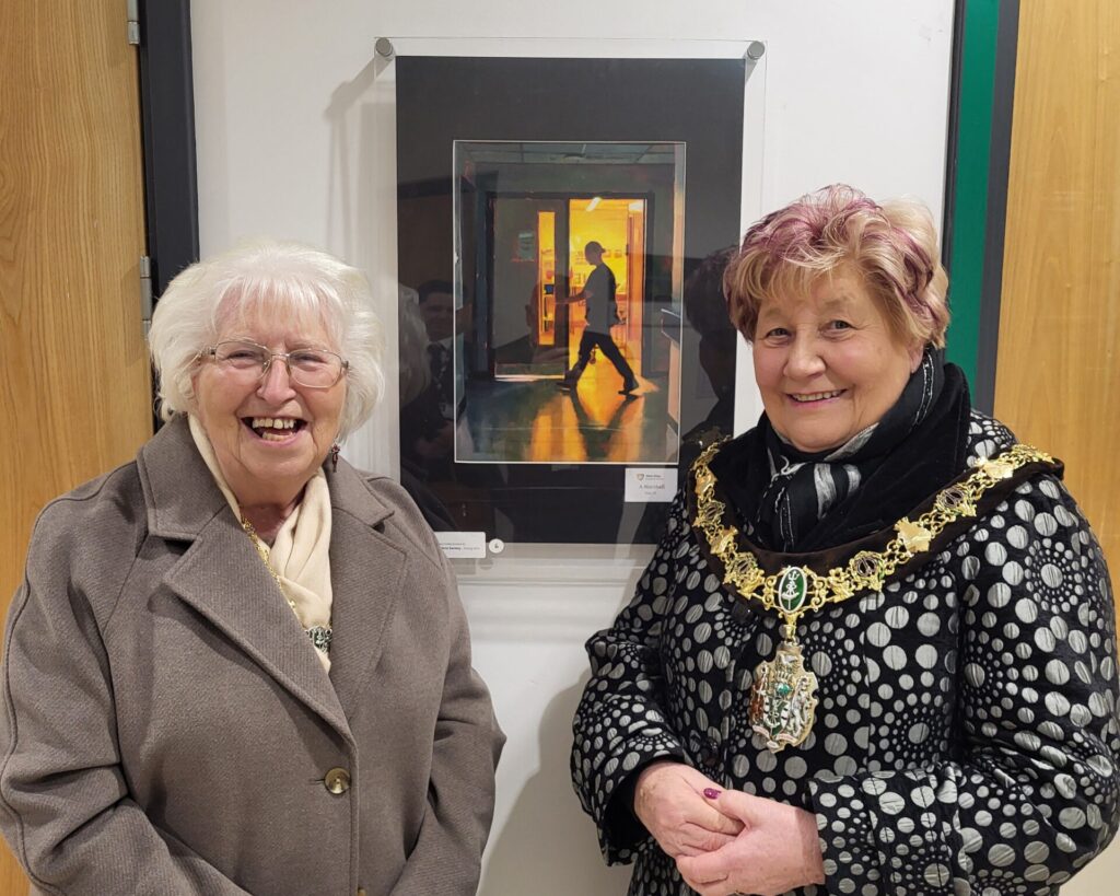 Mayor and Mayoress of Wirral standing by artwork on display