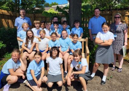 Group of primary age pupils from local school in uniform