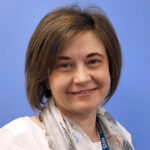 Woman with scarf and NHS badge