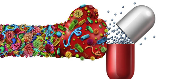 Microbes depicted as a boxing glove 'punching' antibiotic pill