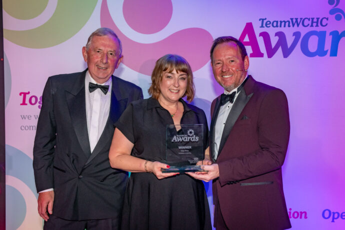 Staff accepting award on stage