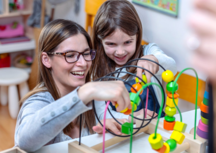 Woman and child smiling and playing.